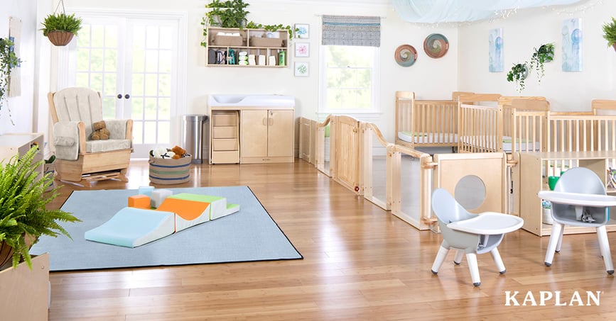 A light and airy infant classroom with light wood furniture