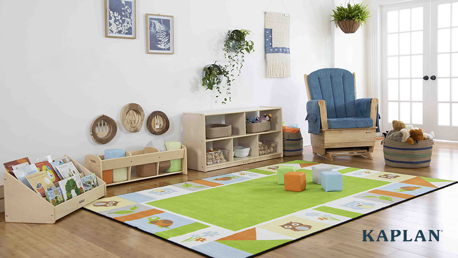 A bright and cheerful infant classroom with light wood furnishings, soft blocks and a variety of books