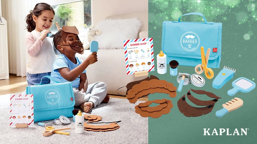 Two children sit on the floor smiling as they play with the Snip & Style Hair Salon Kit. 
