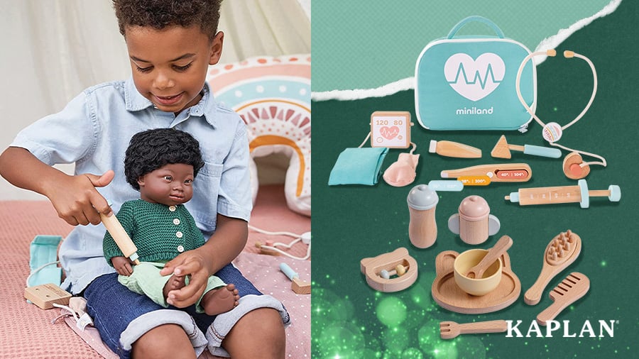 A young child uses a Wooden Doll Wellness Kit to give a shot to a doll in need.