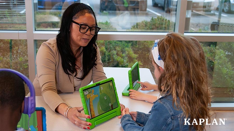 Teacher implementing tablet-based learning with students