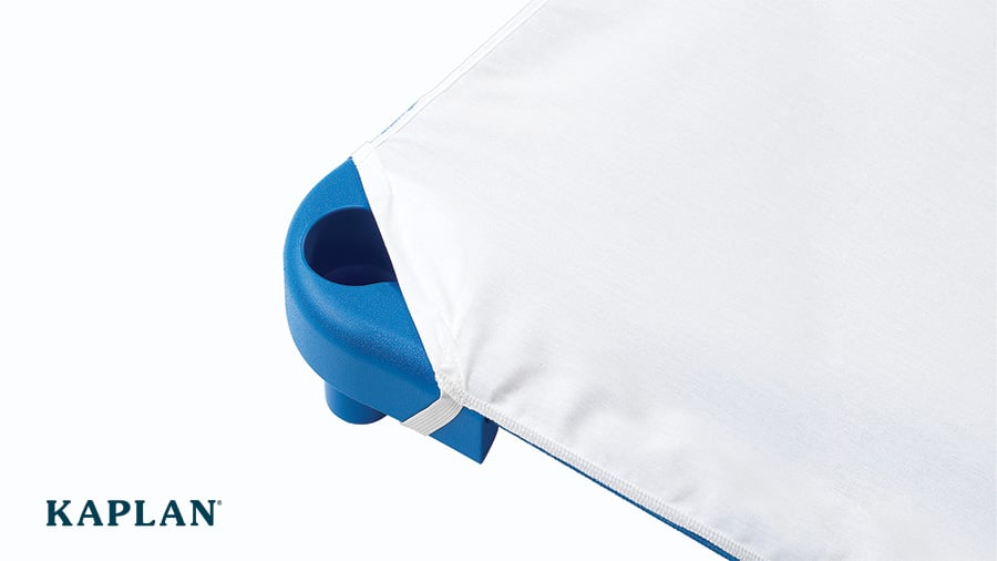 A corner of a cot that has a white sheet with elastic loops fitted to it