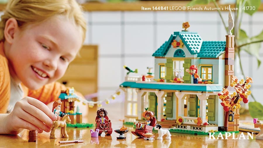 A young child plays with the LEGO Friends Autumn's House set.