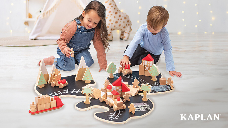 Two children sit on the floor, moving wooden people and cars throughout the Story Island Creative Playset. 