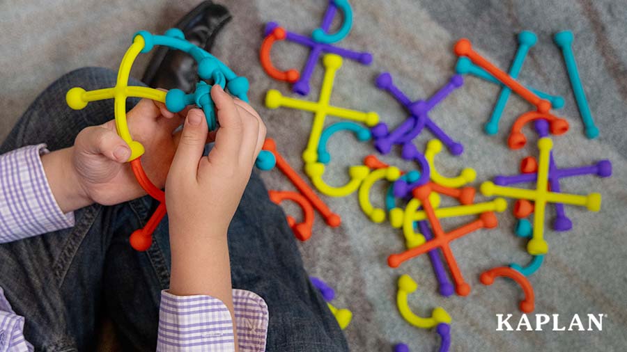An image of a young child's hands creating a sculpture using the Plip Kit Silicone Set. 