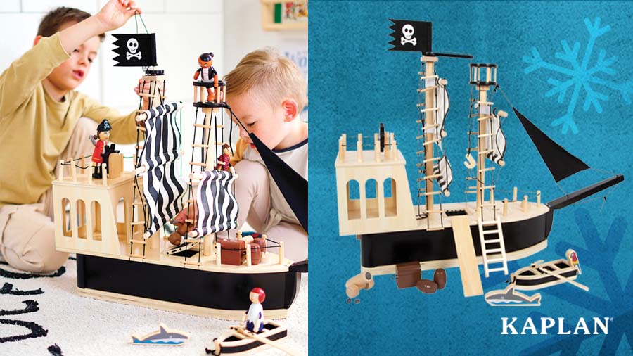 Two young children sit on the floor of their playroom with the Adventure Pirate Ship and accessories. 