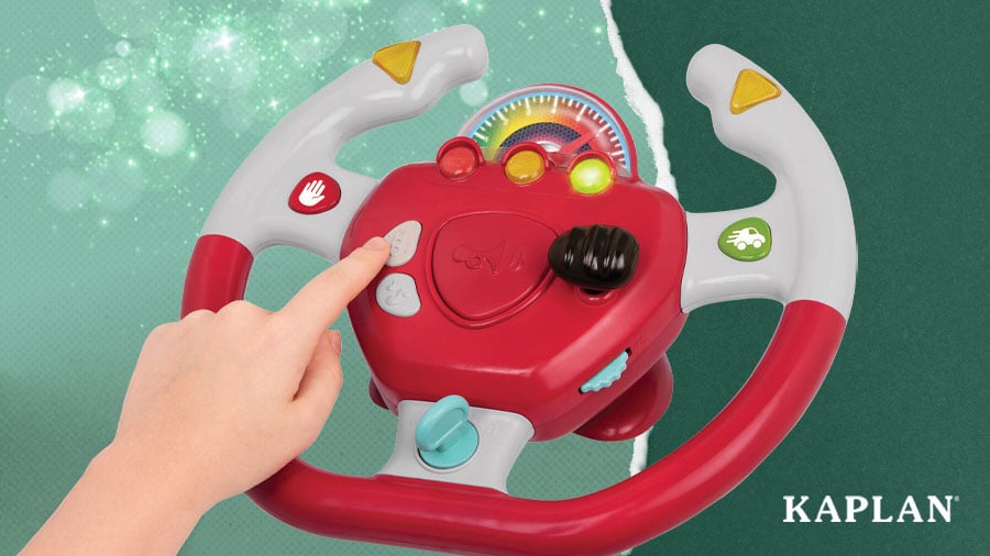A child pushes a button on a Steering Wheel with Lights and Sounds toy. 
