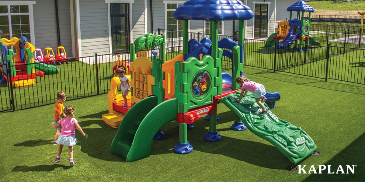Young children exploring a multicolored playground in an outdoor learning environment