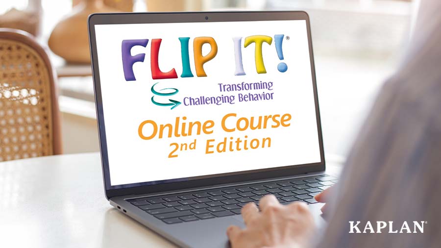 An image of an open laptop on a table, on the screen is the Flip It: Transforming Challenging Behaviors Online Course 2nd Edition. 