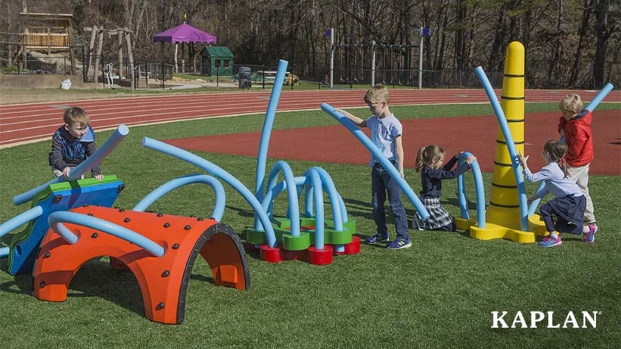 A group of children build an obstacle course using pieces from a SungPlay Kit.