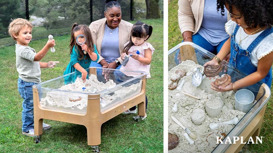 A teacher watches three children dig, play, and explore dinosaur fossils that are hidden in the sand inside a Kaplan Sand and Water Table. 