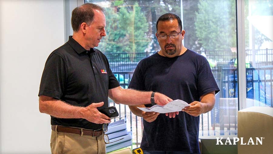 Two members of the K-Truck Delivery and Setup team reviewing a delivery and installation