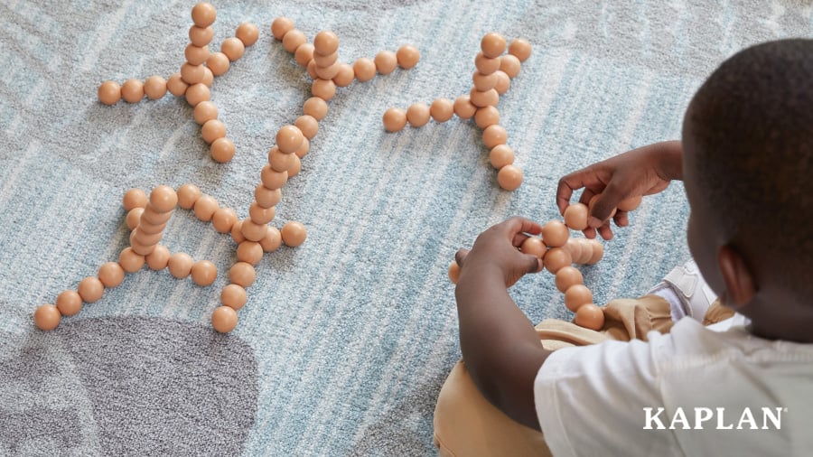 A young child uses Kaplan's Bendi Beads to create unique shapes and structures. 