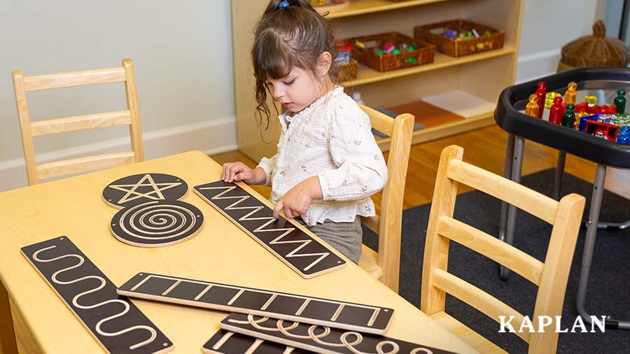 Child tracing a zig-zag design using their finger