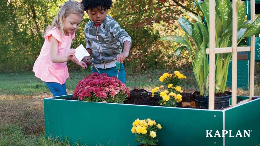 Two children playing in the school's outdoor garden