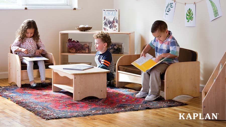 Three children reading independently in a nature-inspired reading nook