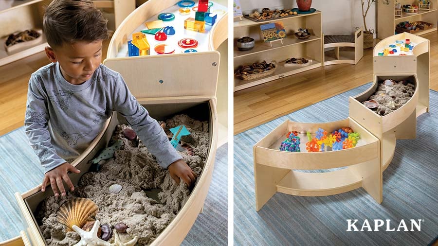 A young child digs in sand to collect sea shells as he plays on the Carolina Connections Discovery Table.