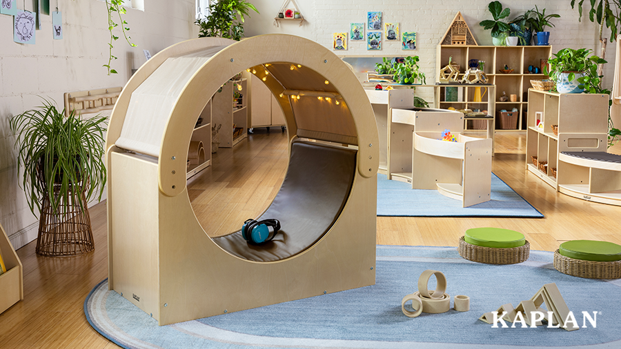 An image of a the Carolina Connections Cove in an early childhood classroom, a pair of blue headphones and set of twinkling lights are inside the hideaway cove. 