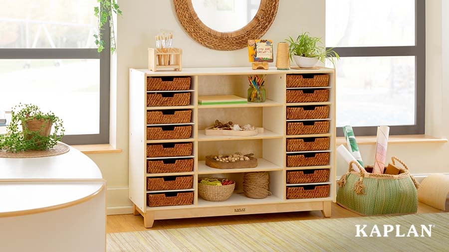 A light-wood Kaplan storage cabinet holding art supplies and natural materials