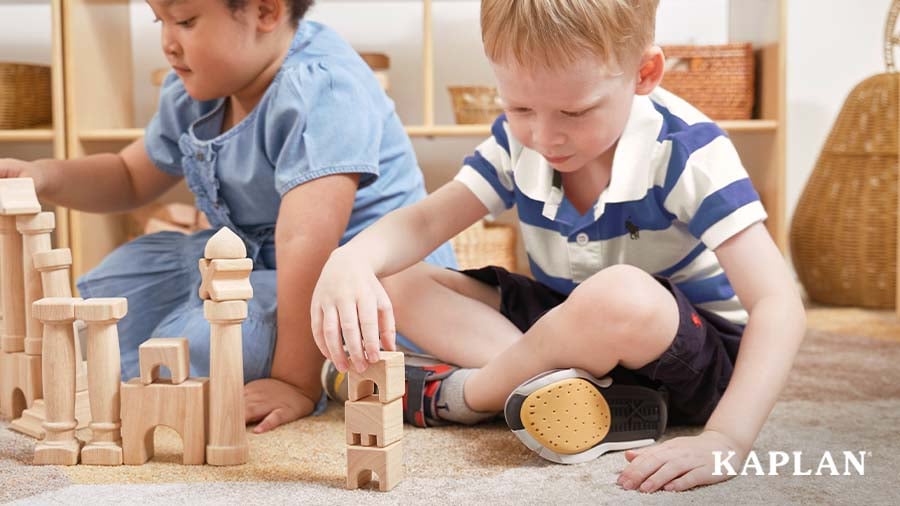 Two children building structures during block play