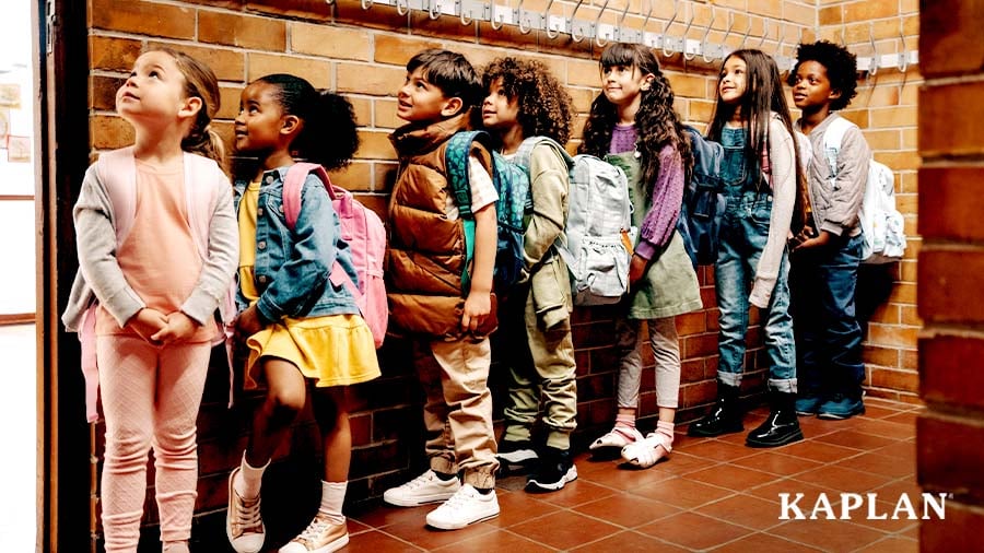 Young children standing in line in a school hallway