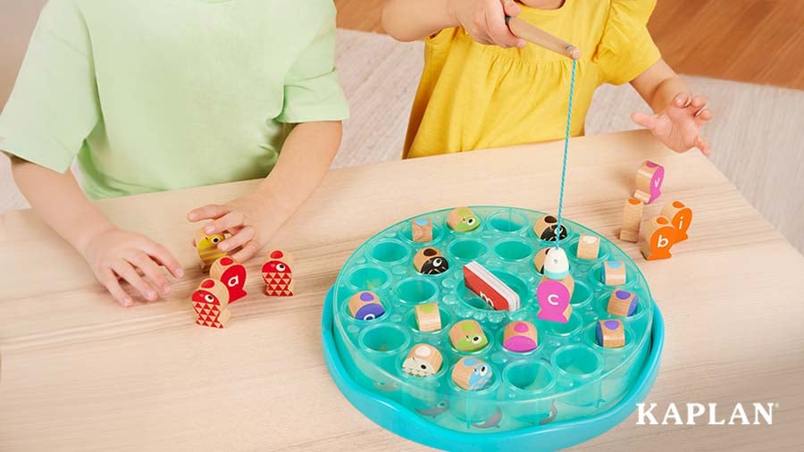 Two children playing a "fishing" phonics game at a table