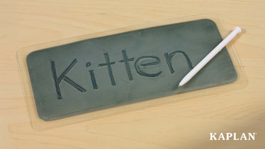 Writing board with the word "Kitten" written on it