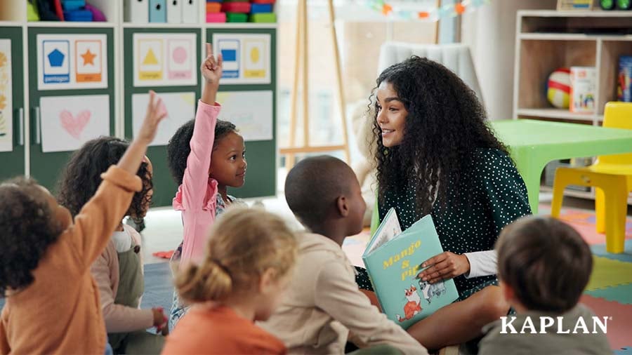 Early childhood educator reading a book to children during circle time