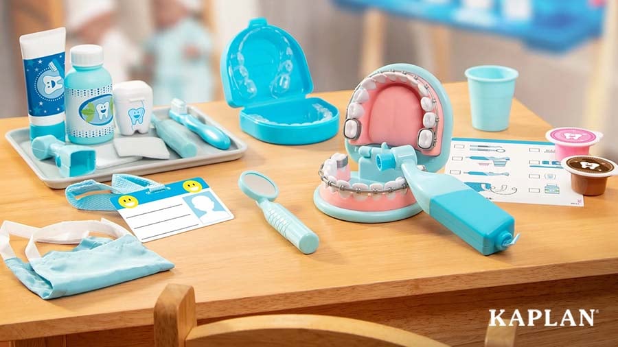 Items from a pretend-play dental kit positioned on a tabletop