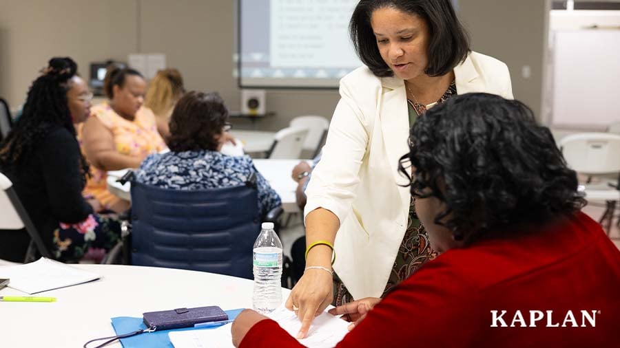 Training facilitator assisting an early childhood educator during in-person training