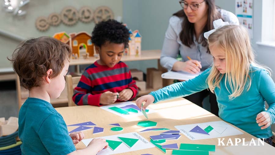 Three children completing a math activity as an early childhood educator observes