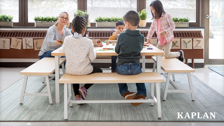 Young children and early childhood educator completing an activity using Sense of Place collaboration table and benches