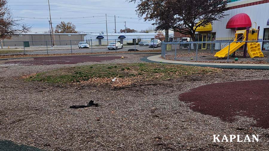 Shown the before playground at Carver Daycare and Preschool. The yard is bare.