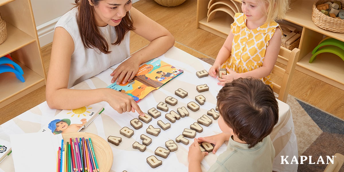 Early childhood educator practicing early literacy skills with two young children