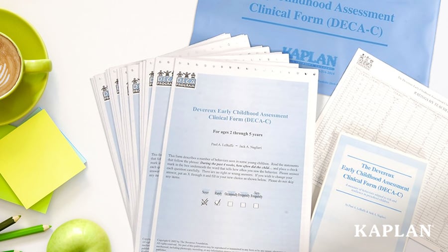 A flat lay image showing a cup of coffee and several DECA clinical forms fanned out on a white tabletop.