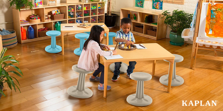 Two children completing an activity while sitting on wobble chairs
