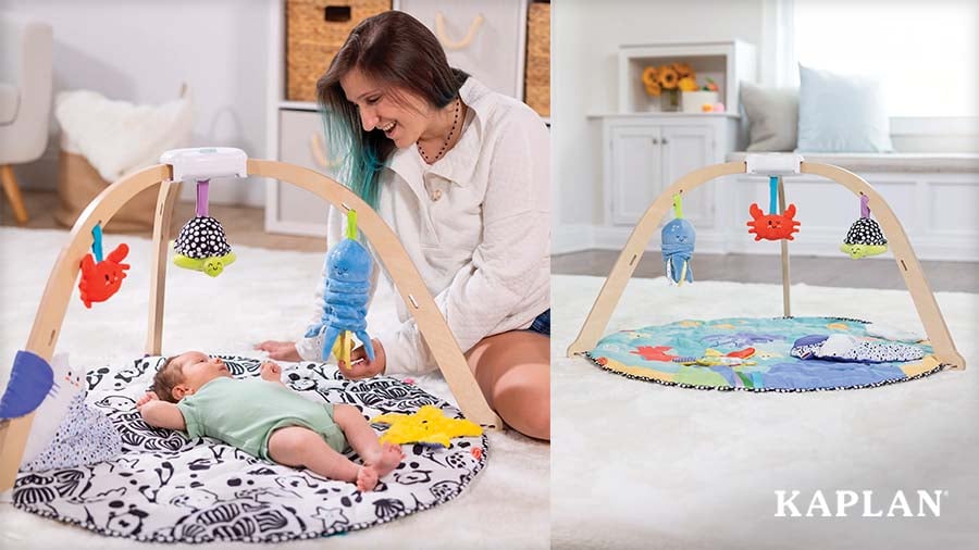 Caregiver engaging with infant lying on the Ocean Easy-Fold Play Gym