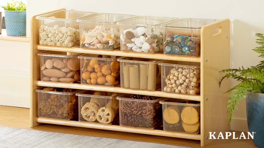 A Carolina See-All Storage unit contains clear plastic bins with a variety of loose parts materials. 