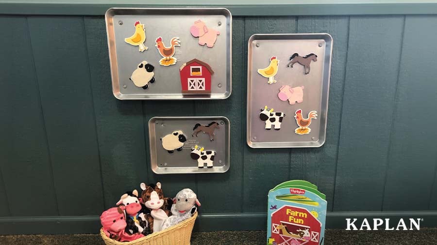 Wall-mounted baking pans with magnetic farm animal pieces attached