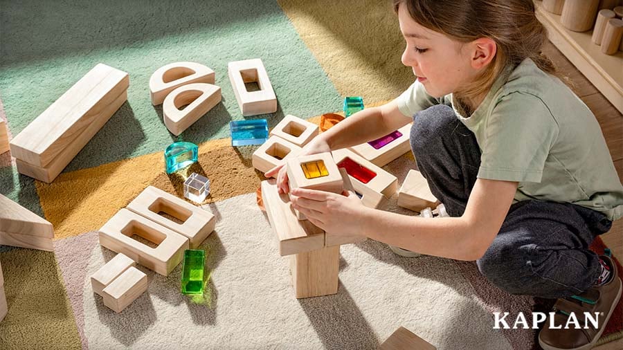 Young child building wooden structures during block play