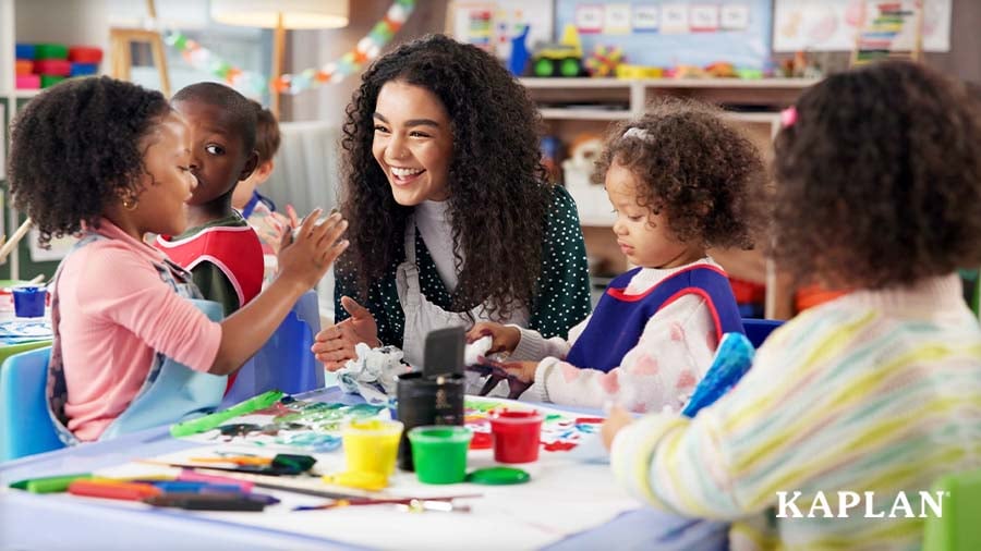 Early childhood educator painting art with young children