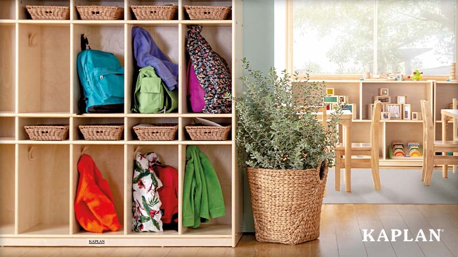 Wooden Kaplan cubby storage unit holding backpacks, jackets, and baskets