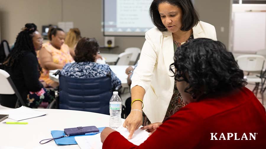 Trainer helping an educator attending a professional development session