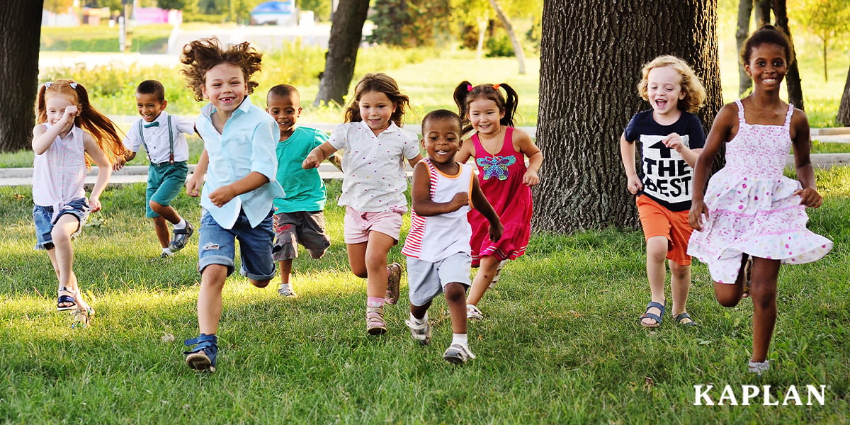 Featured image: A group of young children running in outdoor play area - Read full post: Helping Children Stay Engaged When Energy Levels Run High