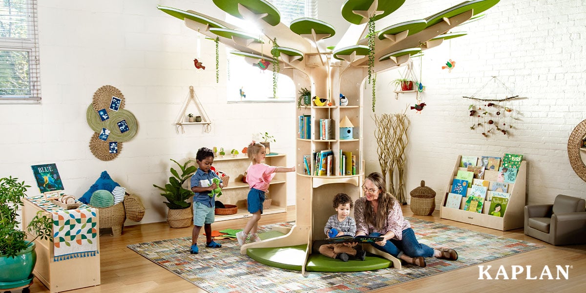 Featured image: Early childhood educator with three children in the reading corner of the classroom - Read full post: How To Design A Nature-inspired Classroom