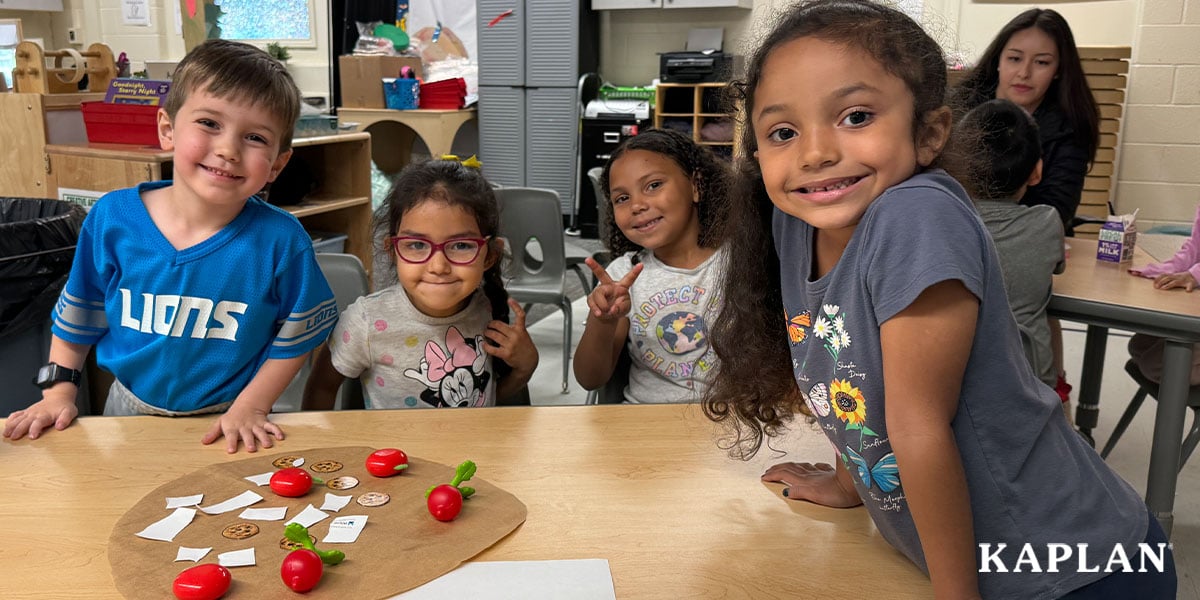 Featured image: Four children stand around a wooden table in their pre-K classroom, they are looking straight at the camera and smiling.  - Read full post: How a Michigan School District Adopted the Connect4Learning® Pre-K Curriculum