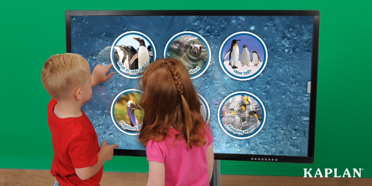 Featured image: Two children stand in front of a Inspire Interactive Panel, featuring a main menu screen with educational apps. One of the children is pointing to an image of a penguin on the screen.  - Read full post: Inspire Interactive Display Panels: Which Style Is Best For Your Classroom?